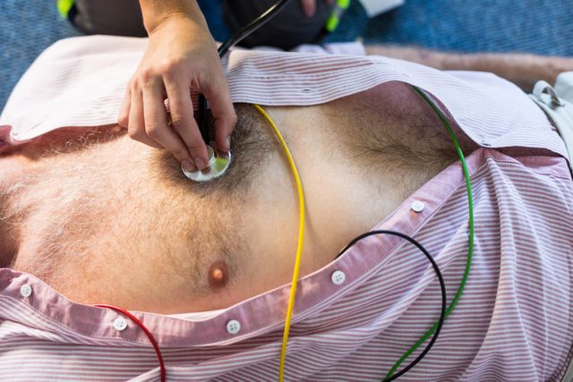 Paramedic examining a patient during cardiopulmonary resuscitation - Download Free Stock Photos Pikwizard.com