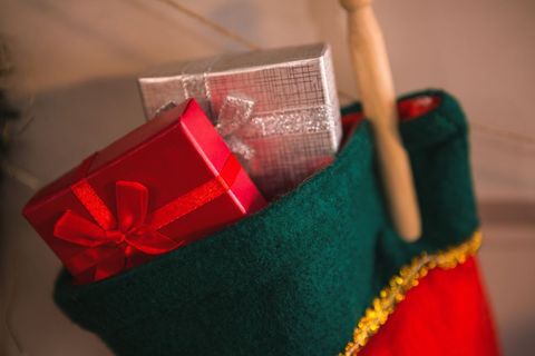 Christmas stockings hanging on fireplace with gifts - Download Free Stock Photos Pikwizard.com