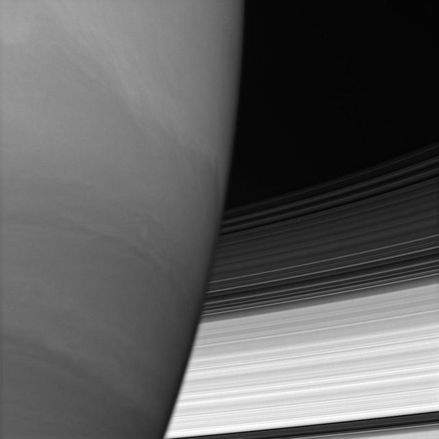 Saturn B and C rings disappear behind the immense planet. Where they meet the limb, the rings appear to bend slightly owing to upper-atmospheric refraction