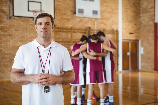 Confident coach standing in basketball court - Download Free Stock Photos Pikwizard.com
