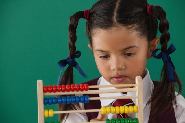 Schoolgirl using abacus against chalkboard - Download Free Stock Photos Pikwizard.com