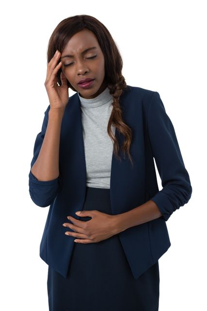 Businesswoman with head in hand suffering from stomach ache - Download Free Stock Photos Pikwizard.com