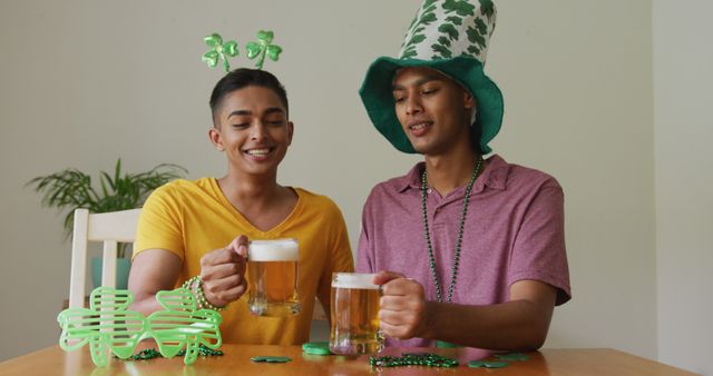 Mixed race gay male couple making st patrick's day image call raising glasses wearing costumes - Download Free Stock Photos Pikwizard.com
