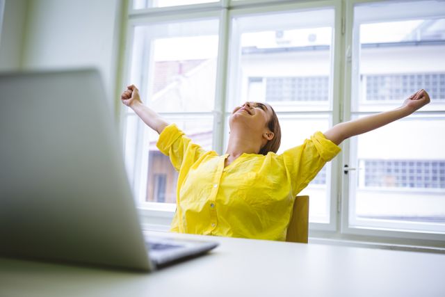 Excited businesswoman with outstretched arms at office - Download Free Stock Photos Pikwizard.com