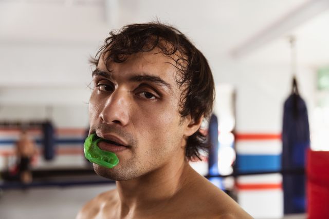 Fit man getting beat up during training in boxing ring - Download Free Stock Photos Pikwizard.com