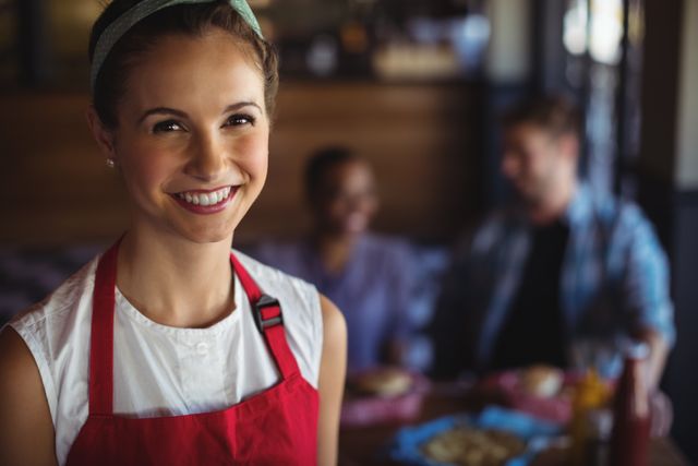 Smiling waitress at restaurant - Download Free Stock Photos Pikwizard.com