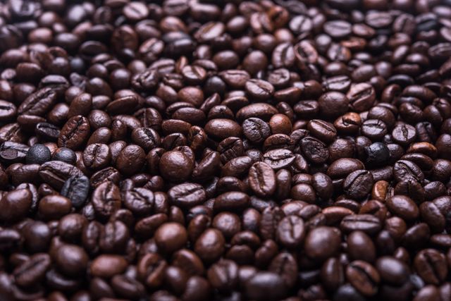 Close up view of brown coffee beans. food and café concept