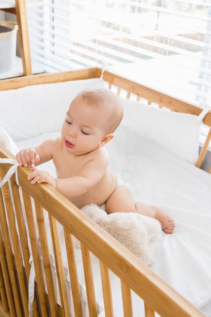 Baby boy playing on a cradle - Download Free Stock Photos Pikwizard.com