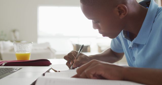 Image of focused african american boy having online lessons at home - Download Free Stock Photos Pikwizard.com