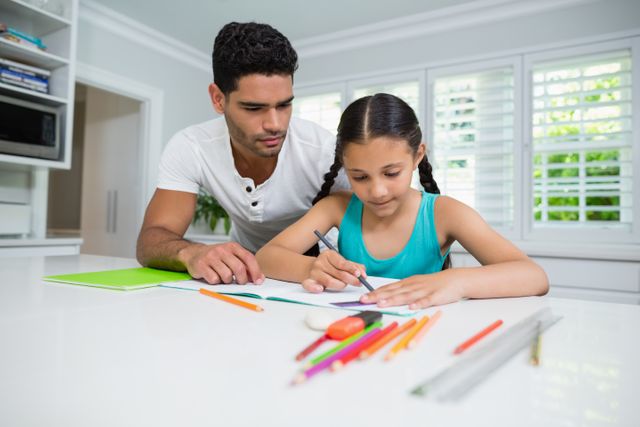 Father assisting her daughter in doing her homework - Download Free Stock Photos Pikwizard.com