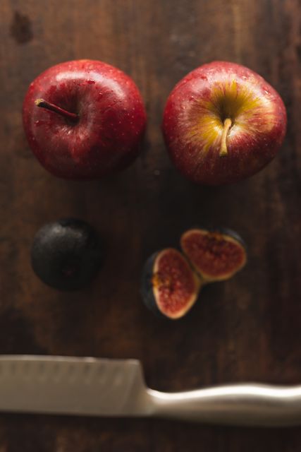 Close up view of apples and fig on wooden table - Download Free Stock Photos Pikwizard.com