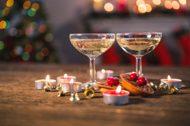 Wine glasses with christmas decorations on wooden table in living room