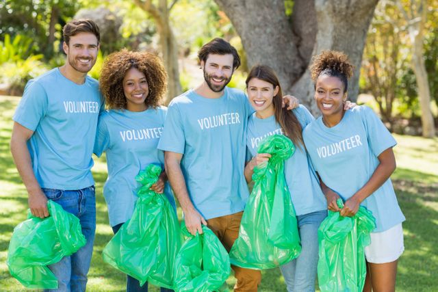 Portrait of volunteer group posing while collecting rubbish - Download Free Stock Photos Pikwizard.com