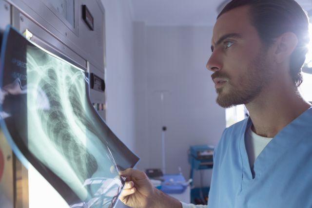 Male surgeon examining x-ray on x-ray light box in operation room at hospital - Download Free Stock Photos Pikwizard.com