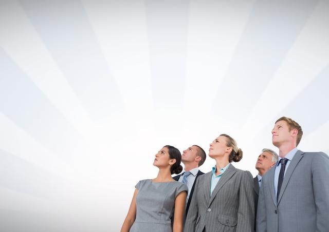 Digital composite of Business people looking up with radial background