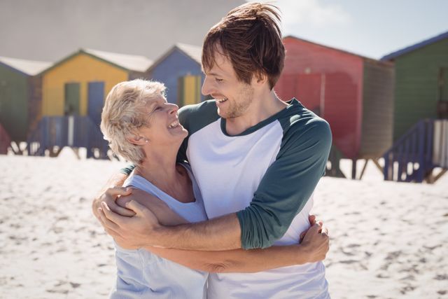 Happy mother embracing her son at beach - Download Free Stock Photos Pikwizard.com