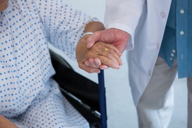 Doctor consoling senior patient on wheelchair at hospital - Download Free Stock Photos Pikwizard.com