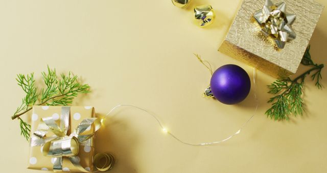 Image of gold and purple christmas decorations and presents on yellow background - Download Free Stock Photos Pikwizard.com