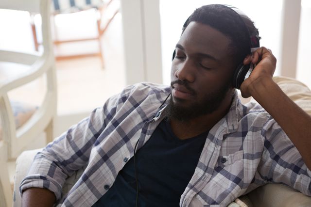 Man sleeping while listening to music at home