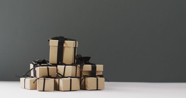 Brown gift box with black ribbon on dark grey background with copy space - Download Free Stock Photos Pikwizard.com