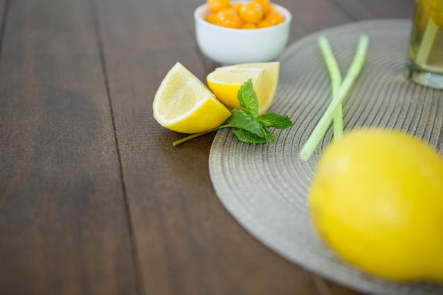 Lemon wedges and mint on wooden board - Download Free Stock Photos Pikwizard.com