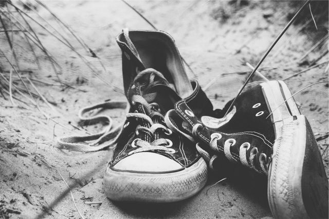 a pair of sneakers on the ground - Download Free Stock Photos Pikwizard.com