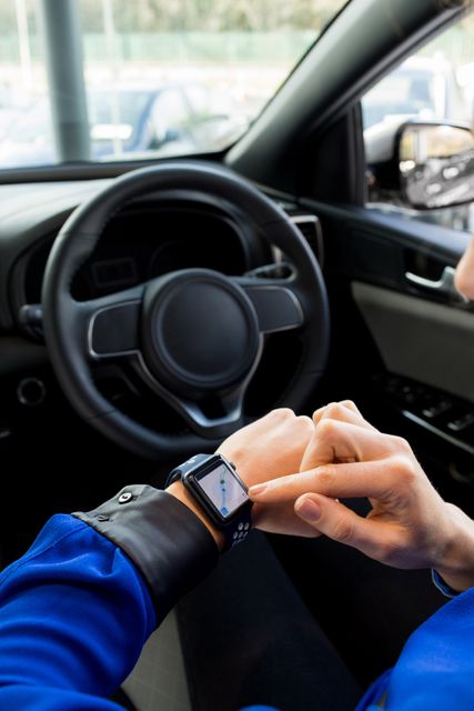Cropped image of woman using smart watch in car - Download Free Stock Photos Pikwizard.com