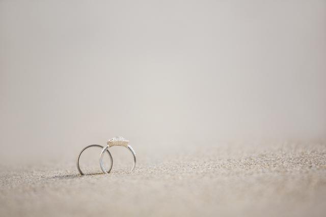 Pair of wedding ring on sand - Download Free Stock Photos Pikwizard.com