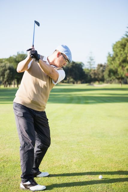 Golfer raising his golf club - Download Free Stock Photos Pikwizard.com