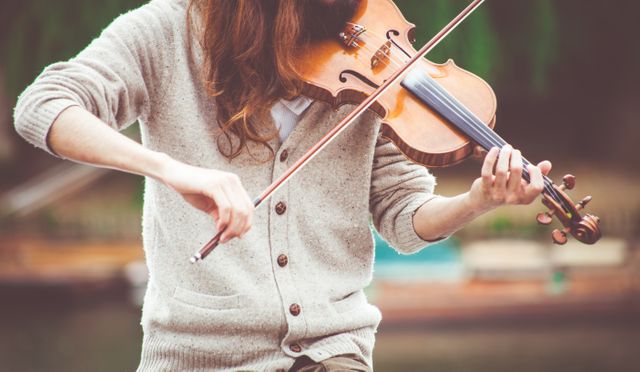 Woman in Gray Cardigan Playing a Violin during Daytime - Download Free Stock Photos Pikwizard.com
