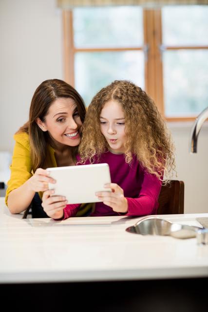 Mother and daughter using digital tablet - Download Free Stock Photos Pikwizard.com