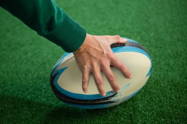 Cropped hand holding rugby ball - Download Free Stock Photos Pikwizard.com