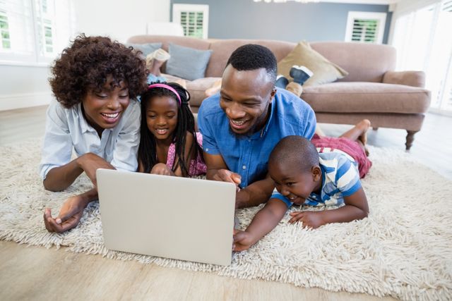 Happy family using laptop in living room at home