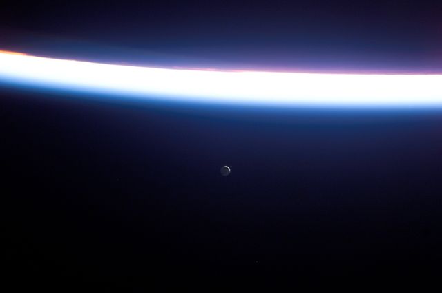S114-E-7558 (6 August 2005) --- This view featuring a distant Moon and a line of airglow of Earth&#0146;s atmosphere was photographed by an STS-114 crewmember onboard the Space Shuttle Discovery after departure from the international space station.