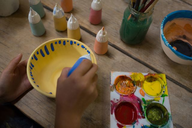 Hand of girl painting bowl - Download Free Stock Photos Pikwizard.com