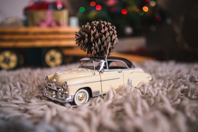 Model vintage car with pine cone on rug - Download Free Stock Photos Pikwizard.com