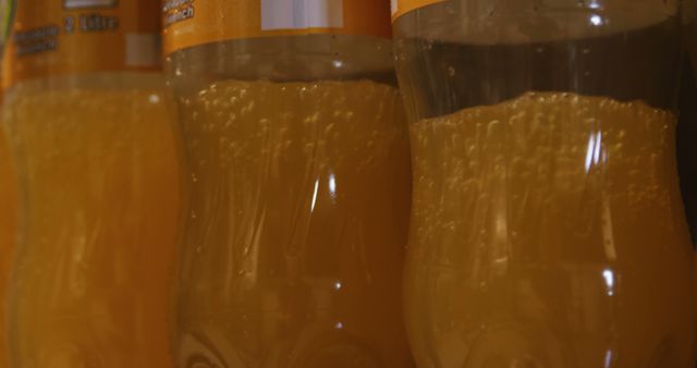 Close up bottles being filled with juice on production line at juice factory
