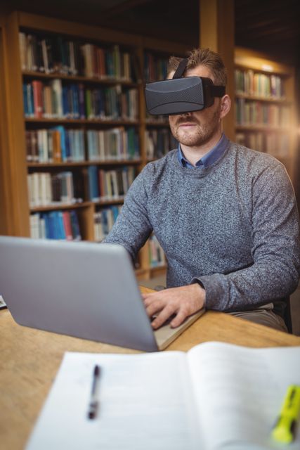 Mature student in virtual reality headset using laptop - Download Free Stock Photos Pikwizard.com