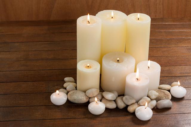 Close- up of white candles and pebbles stone on wood - Download Free Stock Photos Pikwizard.com