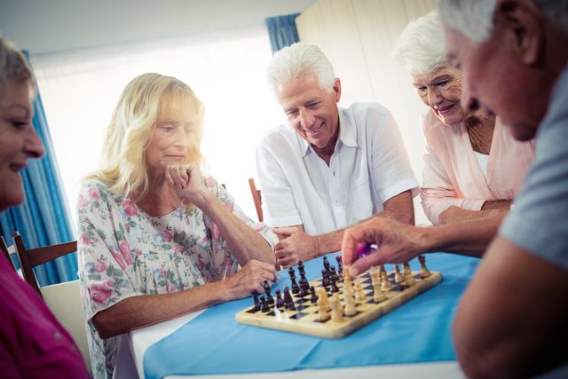 Group of seniors playing chess in the retirement house
