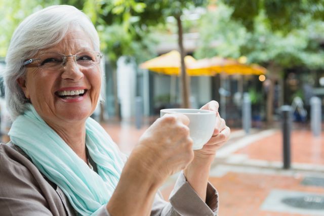 Senior woman holding a coffee cup - Download Free Stock Photos Pikwizard.com