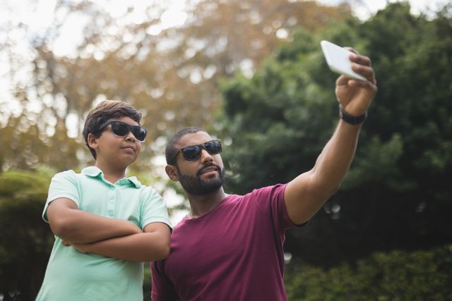 Father taking selfie with son at park - Download Free Stock Photos Pikwizard.com