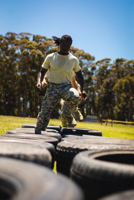 Full length of african american male soldier running through tires during bootcamp training - Download Free Stock Photos Pikwizard.com