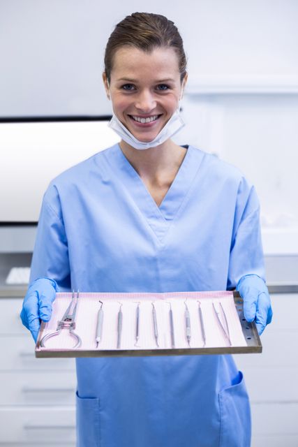 Dental assistant holding tray with equipment - Download Free Stock Photos Pikwizard.com