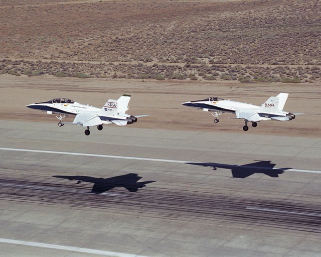 Two NASA Dryden F/A-18's land on the Edwards Air Force Base runway after completion of an Autonomous Formation Flight (AFF) mission.