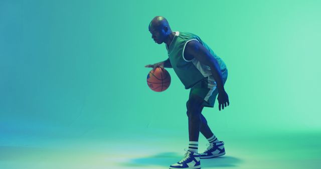 Image of african american male basketball player bouncing ball on blue background - Download Free Stock Photos Pikwizard.com