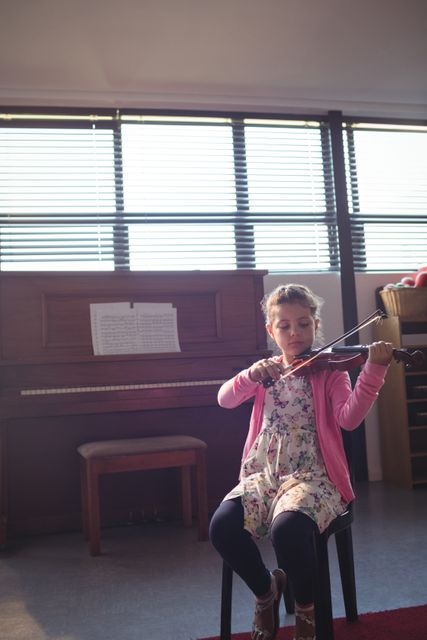 Elementary girl rehearsing violin - Download Free Stock Photos Pikwizard.com