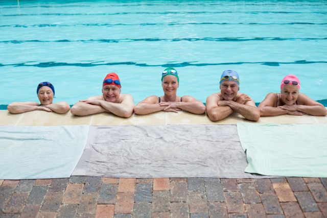 Senior swimmers leaning on poolside - Download Free Stock Photos Pikwizard.com