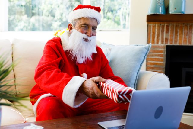 Side view of an old caucasian man wearing a santa clause costume holding out a christmas gift showin - Download Free Stock Photos Pikwizard.com