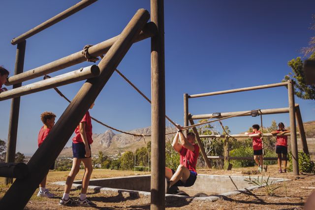 Trainer assisting kids in obstacle course training - Download Free Stock Photos Pikwizard.com